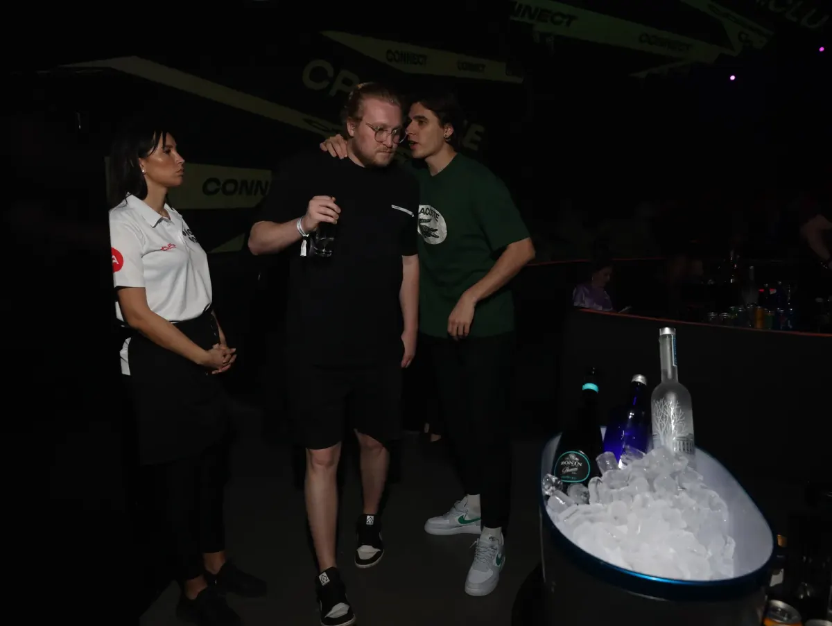 Guests talking at an event venue with drinks and an ice cooler, suited to real estate and developer events in Dubai